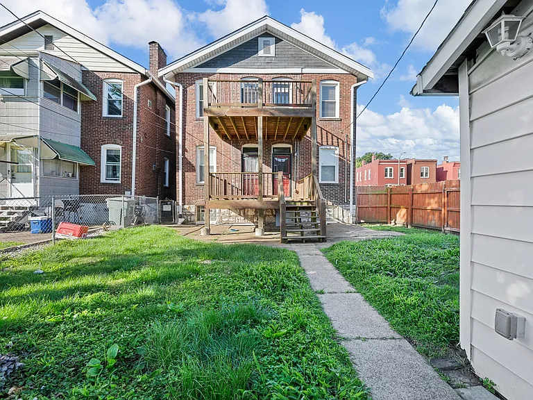 Fenced back yard with garage
