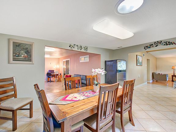 View of the dining room onto the family room (left) and parlor (right) in the distance. Fireplace is outside the frame, to the left.