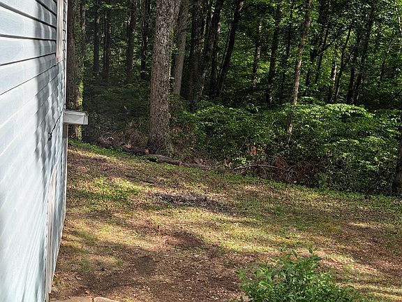 side yard with entrance to basement with washer and dryer hook-up