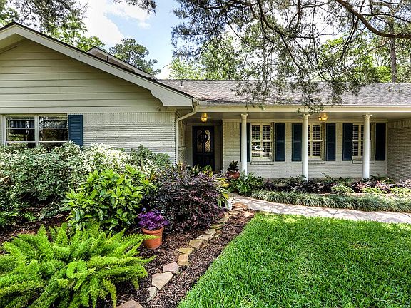 Classic lines and styling with a charming appeal. Front windows with plantation shutters in dining room look over expansive yard. Lovely covered front porch is great for sitting and enjoying the yard.