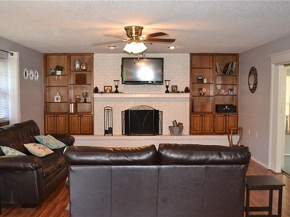 Living area with fireplace and built-in bookshelves.  Sliding door to the right goes to the florida room.