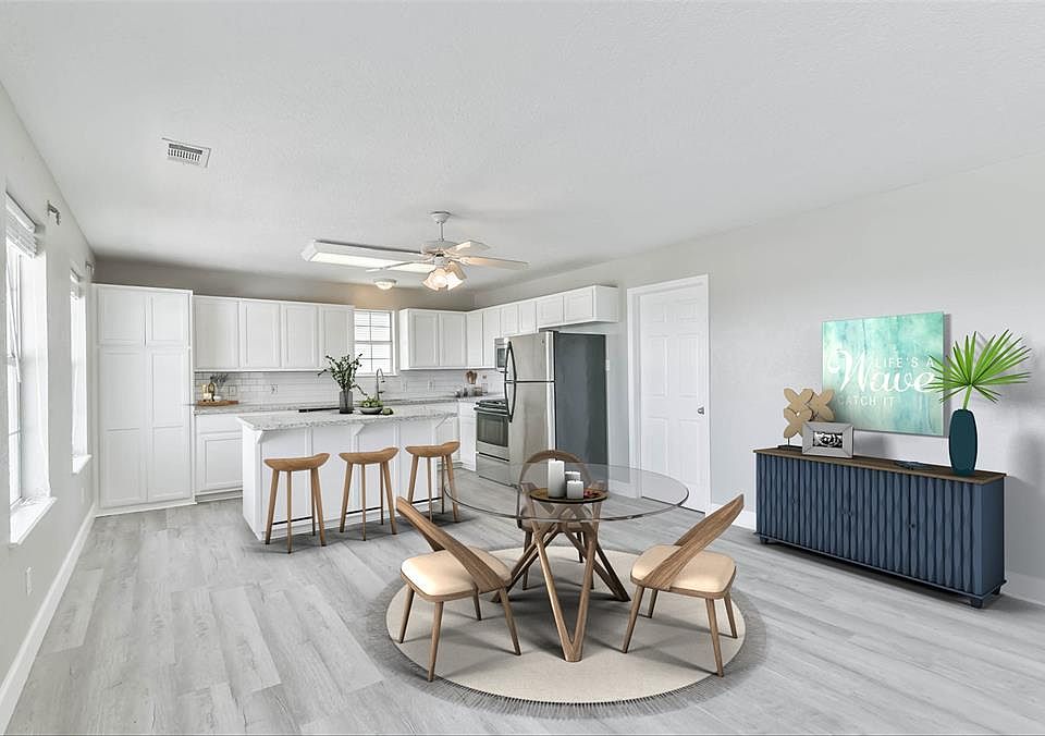 This open concept home features a bright kitchen with a large island, new granite countertops, and stainless appliances.*virtually staged
