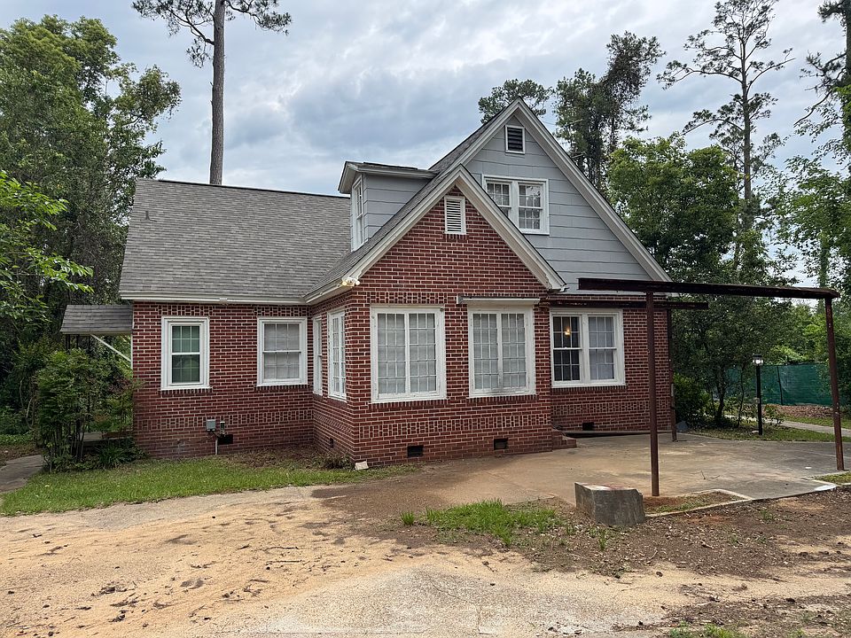 view of 2 story brick house
