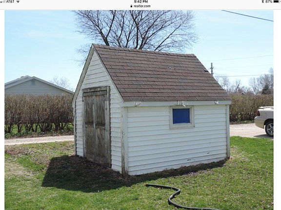 Small outbuilding with ramp doors for lawn mower etc
