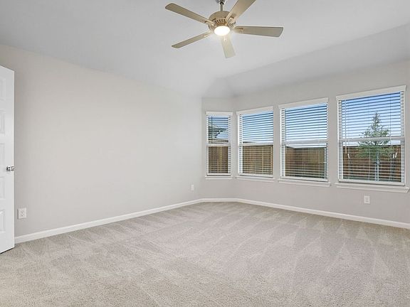 Primary bedroom in the Pulitzer home plan by Trophy Signature Homes - REPRESENTATIVE PHOTO