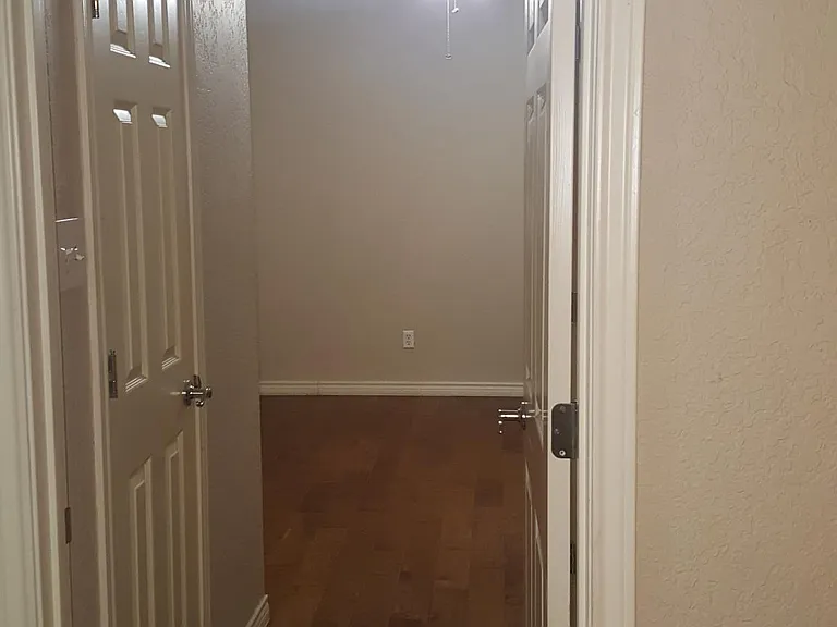 Bed room from kitchen area. Door on left is walk in closet