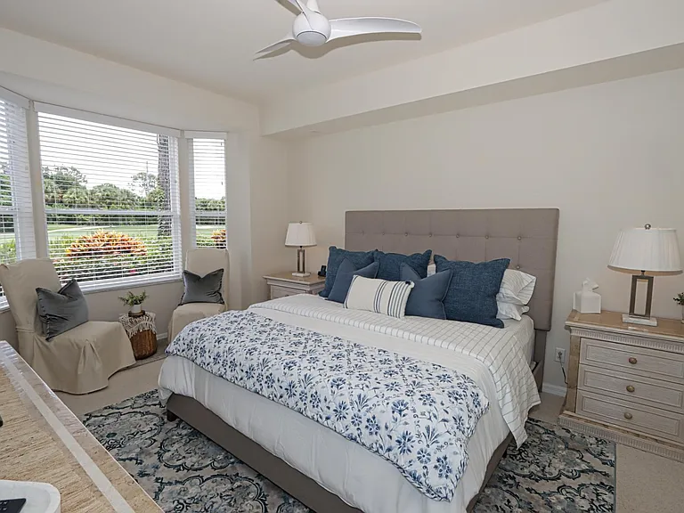 Master Bedroom overlooks the golf course and features a king-size bed, TV, two walk-in closets, a sitting area, and an ensuite bathroom