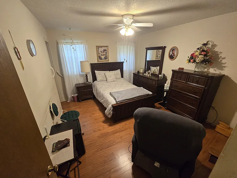 Master bedroom comes with the queen size adjustable bed, an electric recliner, dresser, vanity, nightstand, mini-fridge and His & Hers closet with two doors, and the walk-in tub.