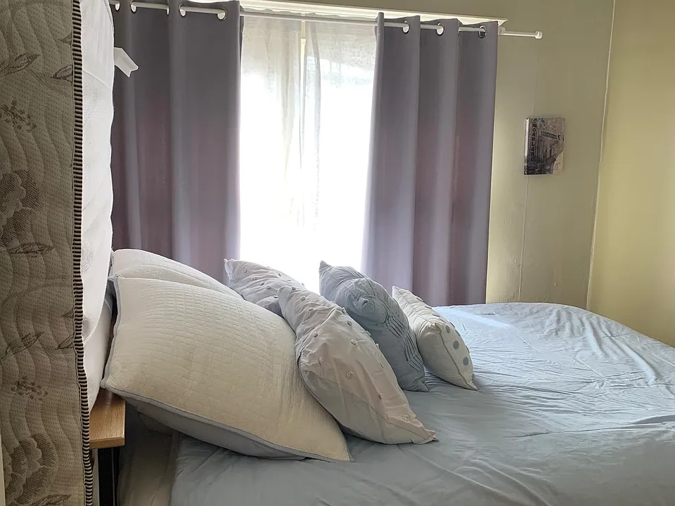 Bright bedroom with a queen size bed.