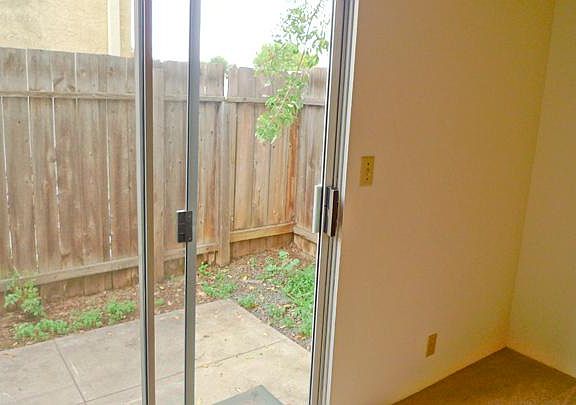 Bedroom / Patio; stock photos of similar unit. Available unit has tile throughout and luxury "wood" plank flooring in bedroom