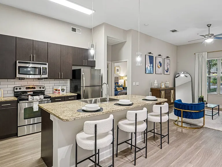 Contemporary kitchen featuring sleek stainless steel appliances at Addison Keller Springs in Addison, TX.