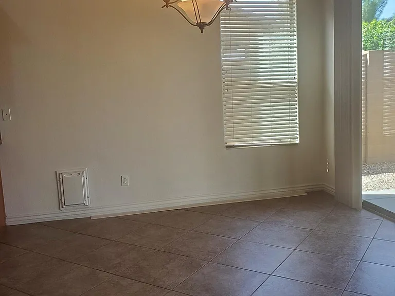 DINING IN GREAT ROOM. OPENS TO BACKYARD WITH FULL LENGTH AND VIEW FENCE.