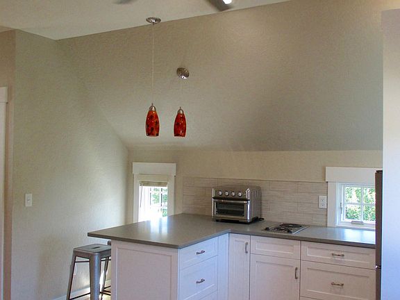 Efficiency kitchen with granite counter and custom wood cabinets