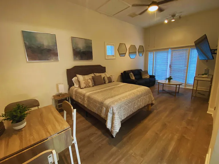 Charming studio with dining table for 4, decor accents, and wall art.
