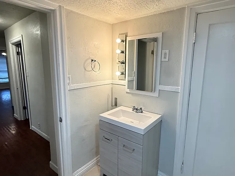 Modern bathroom vanity with contemporary finishes, bright lighting, and extra storage.