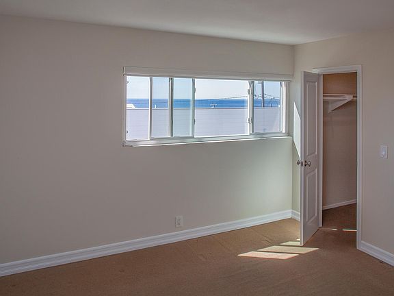 Bedroom with ocean view - walk-in closet. A queen bed and dresser fits nicely.