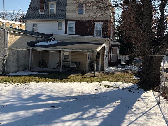 Fenced in back yard with rear porch
