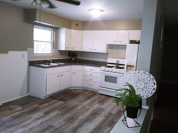 Kitchen leads to one car garage and two car parking driveway.