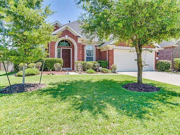 The wide driveway leading to the two car garage provides plenty of off-street parking for both homeowners and guests. HOA fees include security monitoring service.