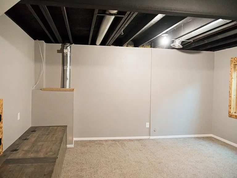 Basement with built in storage bench