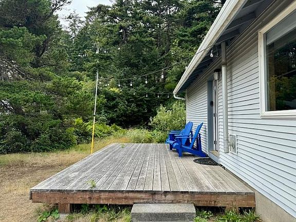 Front of house with deck and chairs