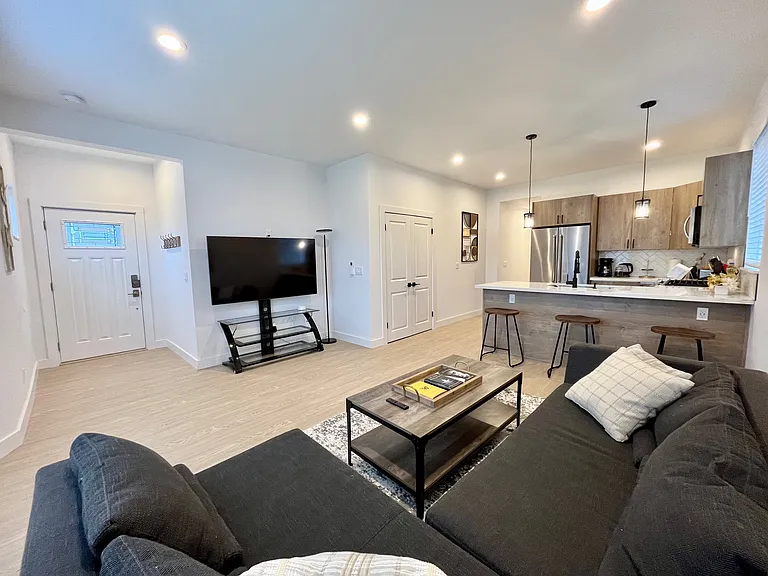 Stay entertained in elegance: Kick back and relax in our stylish living room, featuring a state-of-the-art TV for your viewing pleasure.