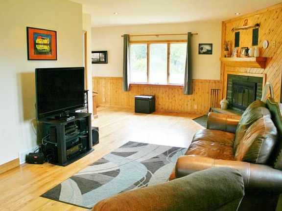Striking wood floors were installed highlighting the wainscoting and fireplace in the living room.