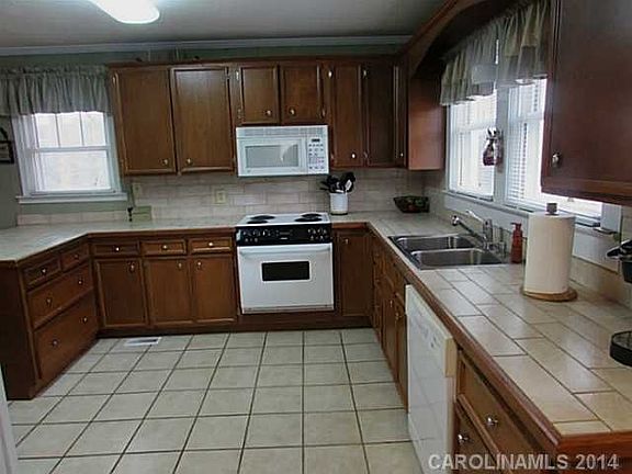 Spacious kitchen with custom cabinets and pantry.