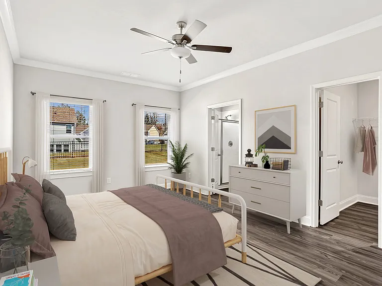 Primary Bedroom with king size bed and large window letting in nice natural light.