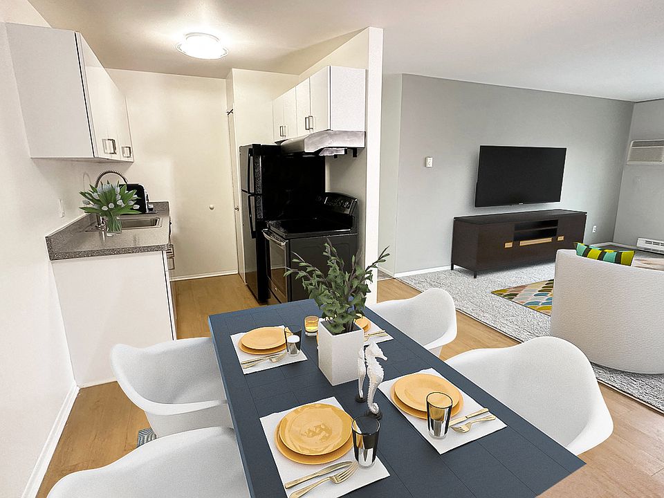 White sleek cabinets, stainless or black appliances, wood plank floors.