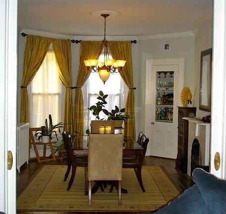 Large dining room with tall ceilings and original hard wood