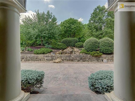 Stately porch that overlooks waterfall and lots of greenery...