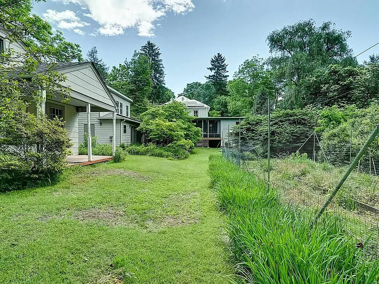 Cottage (nearest), garage, and main house
