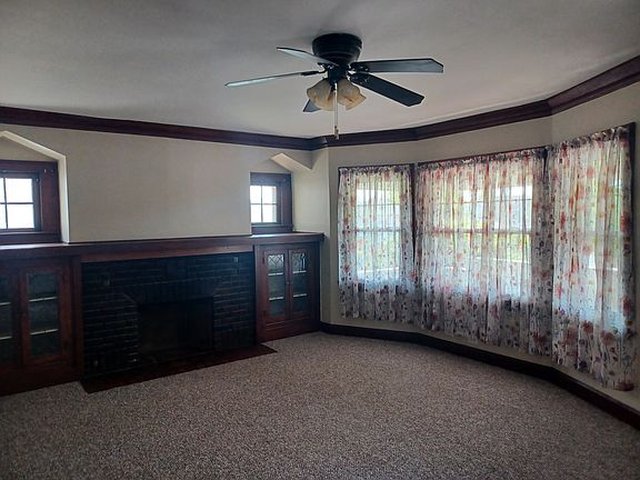 Living room newer bay windows and optional window treatments for tenant use.