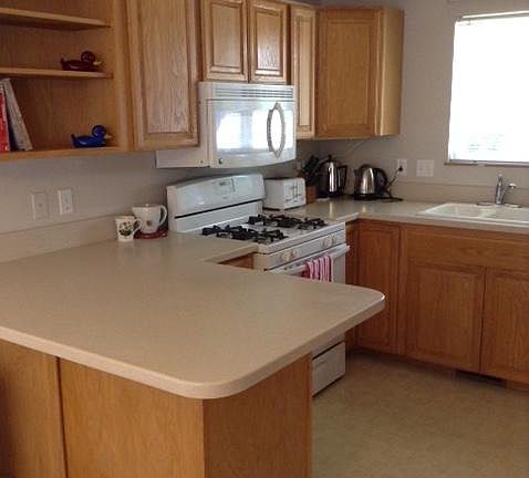 Gas stoves and Corian countertops offer plenty of space