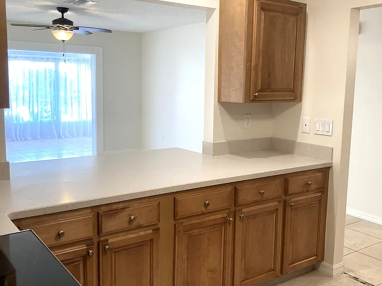 Easy entertaining with view of family room and enclosed lanai