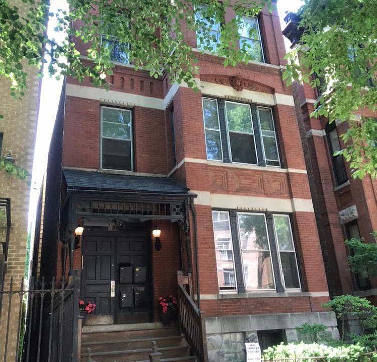 Exterior of Victorian 3 flat on quiet tree lined street