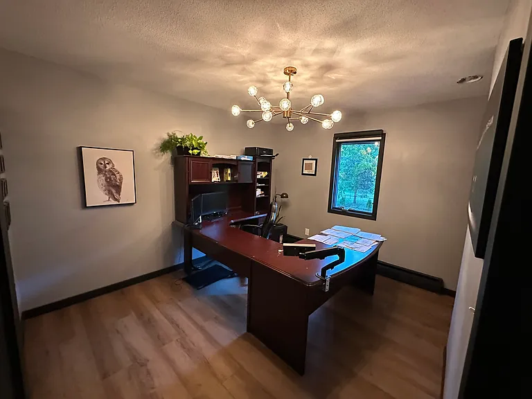 Second bedroom upstairs is conveniently located next to primary suite. Currently used as office space with natural light in the morning.