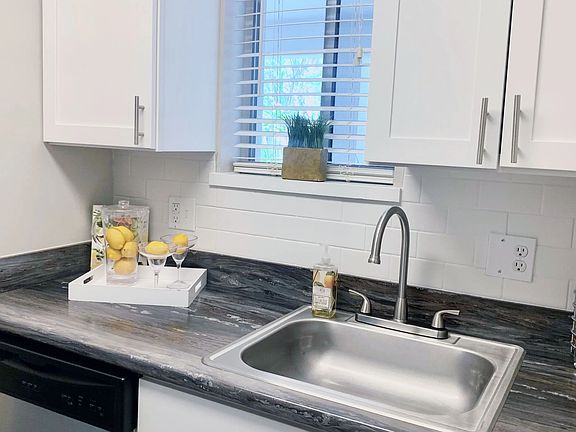 Enjoy an elegant studio kitchen with stainless-steel appliances, including a dishwasher, for inspired living with convenience and charm.