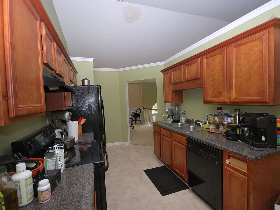 Beautiful stained cabinets & black faced appliances