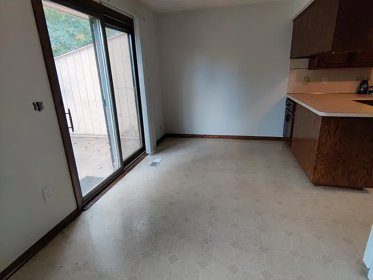Dining area. Kitchen to the right, patio to the left.