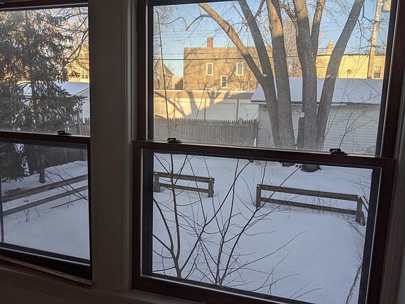 Sunroom windows overlooking backyard brick patio under the snow!
