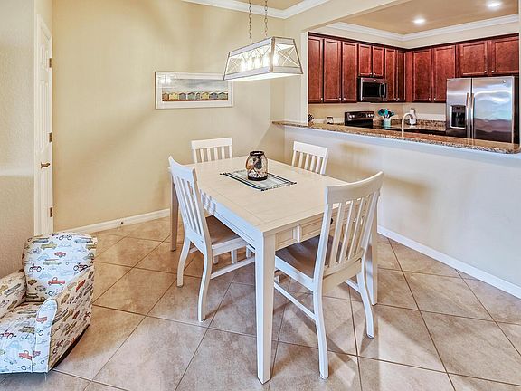 Dining table can be extended with the extra leaves and chairs. The open kitchen allows for ease of passing food into the dining area.