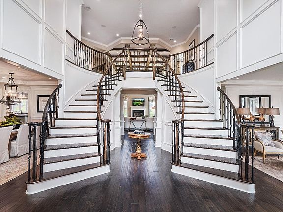 Dramatic entry foyer with double staircases - shown with optional curve