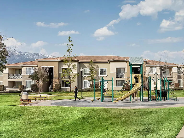 On-Site Play Area with Picnic Benches and Scenic Community Views