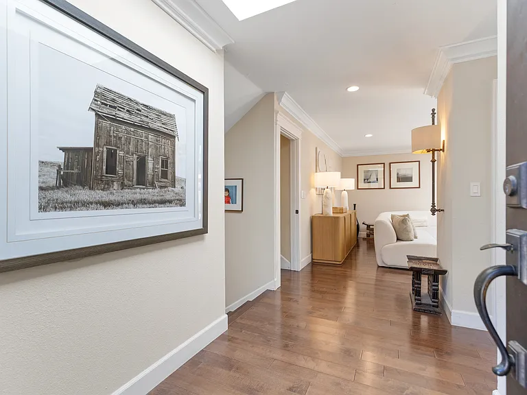 Welcoming foyer leads to living area ahead and to the right, the kitchen/dining room