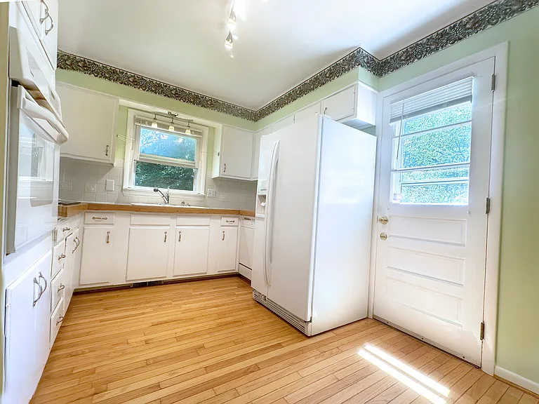Bright kitchen opens to the garden.