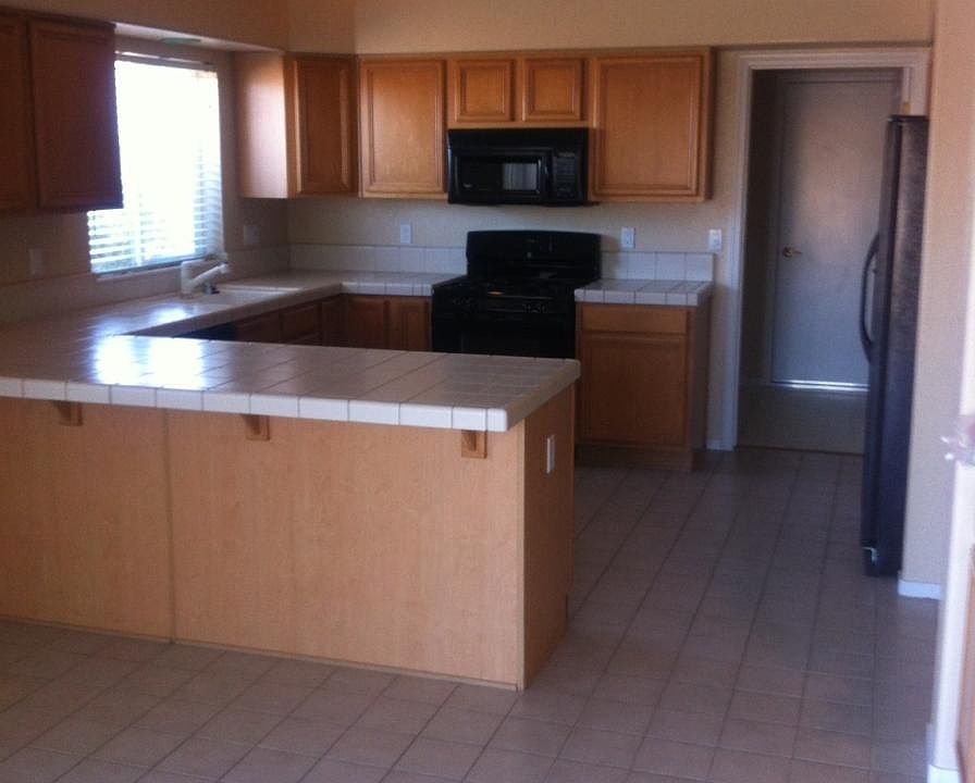 View from Dining Area toward kitchen, laundry room and door leading to garage.