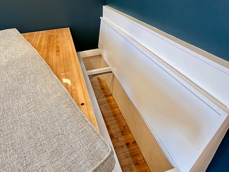 Extra storage under the banquette seating. Note the custom cushion that matches the custom couch fabric.