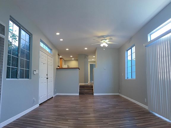 Common area and stairs to kitchen, laundry room, bathroom and two bedrooms.